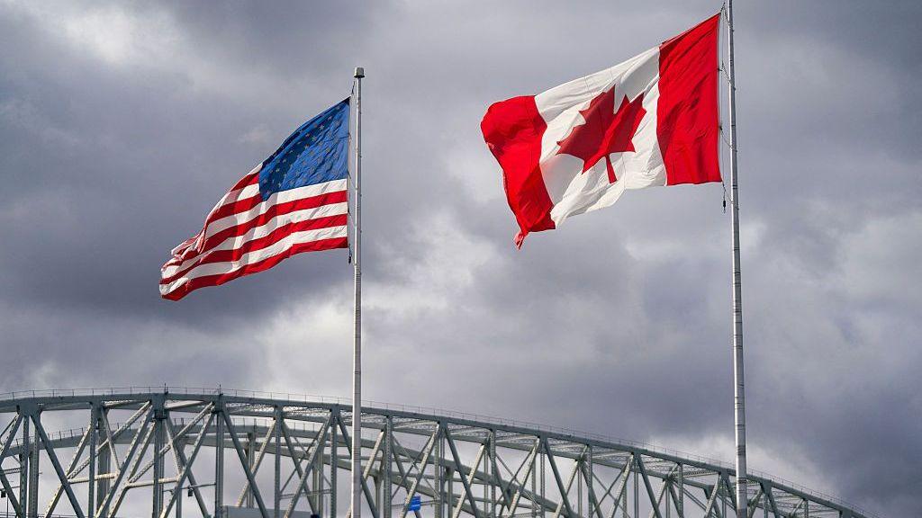 US and Canada flags beside Blue Water Bridge