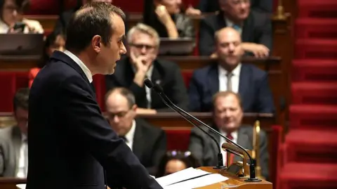 French PM Proposes Suspension of Macron's Pension Reforms to Ensure Government Stability